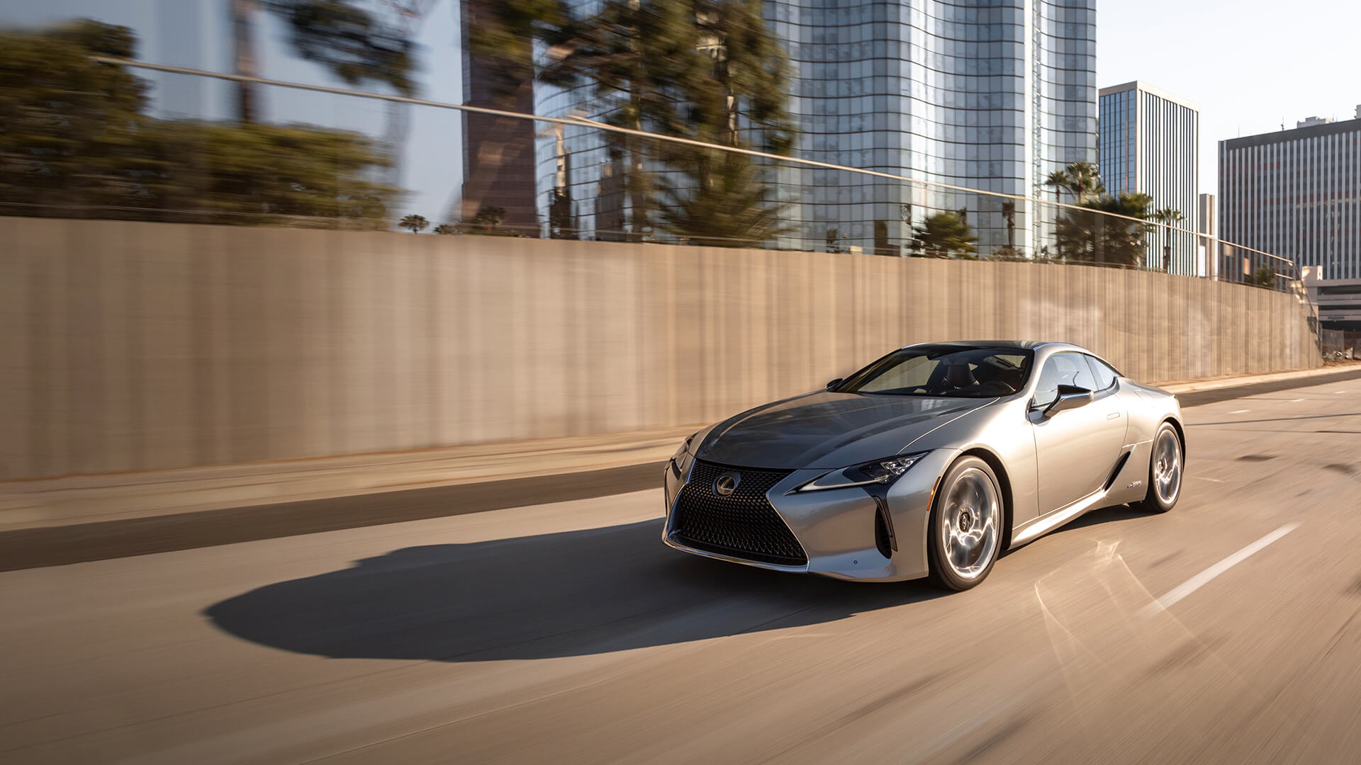 Silver Lexus LC being driven on the road.​