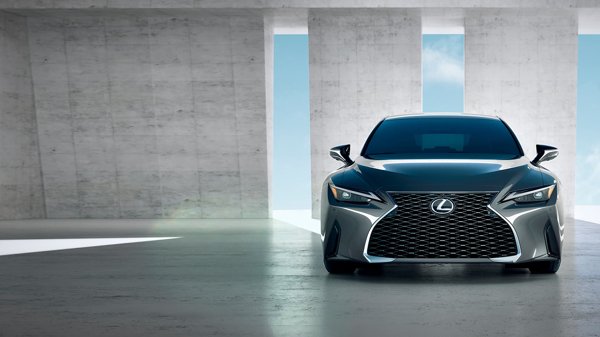 Silver Lexus IS parked in front of two pillars