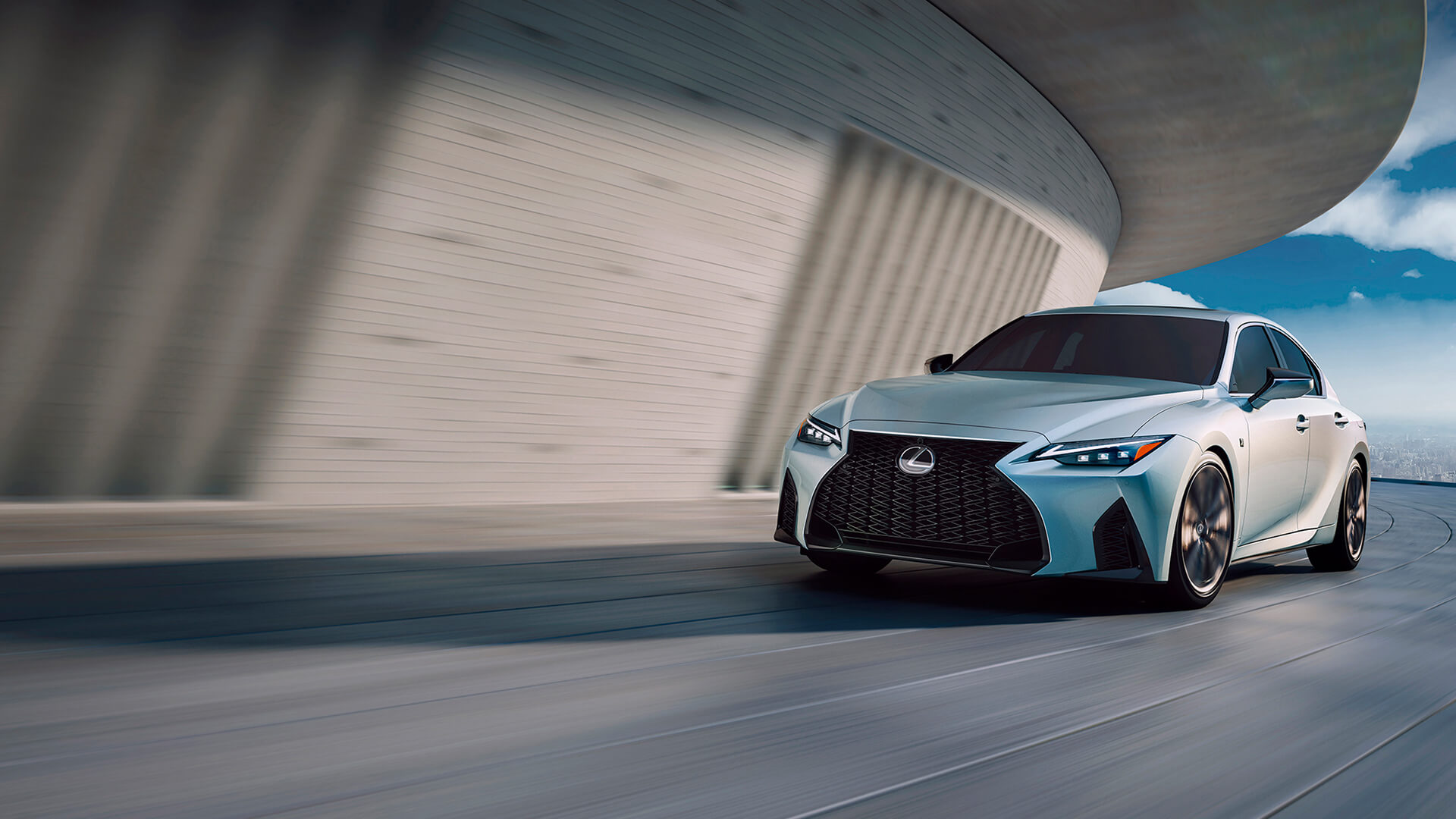 White Lexus IS being driven in an urban building