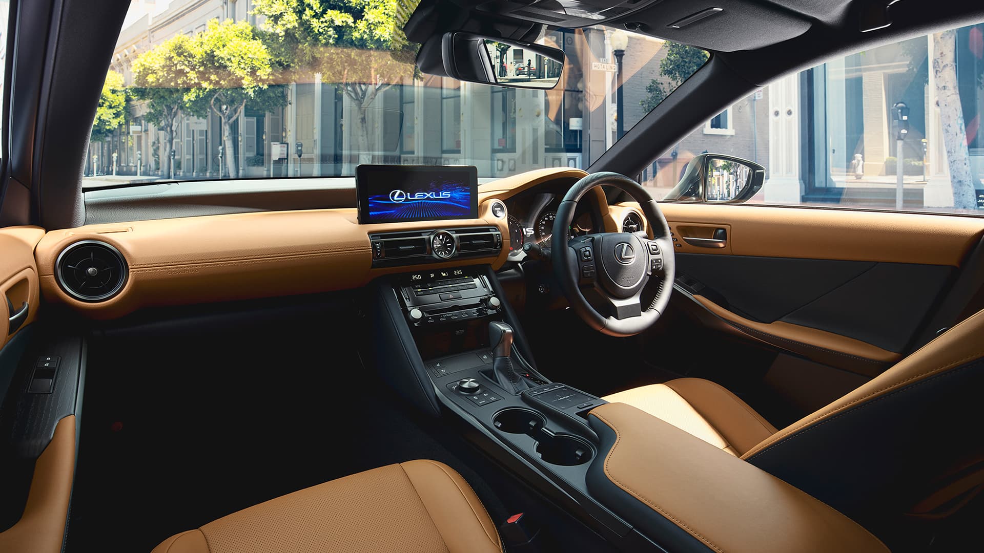 Silver Lexus IS being driven on the road.